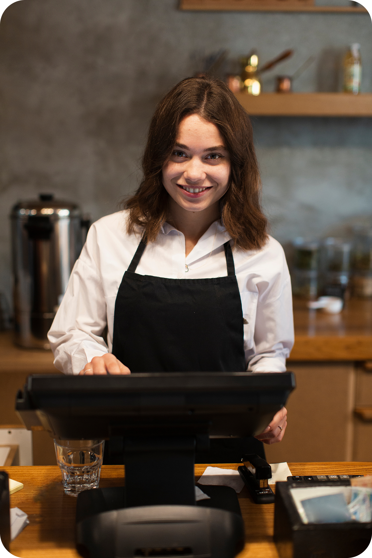 Cashier using POS system with a smile